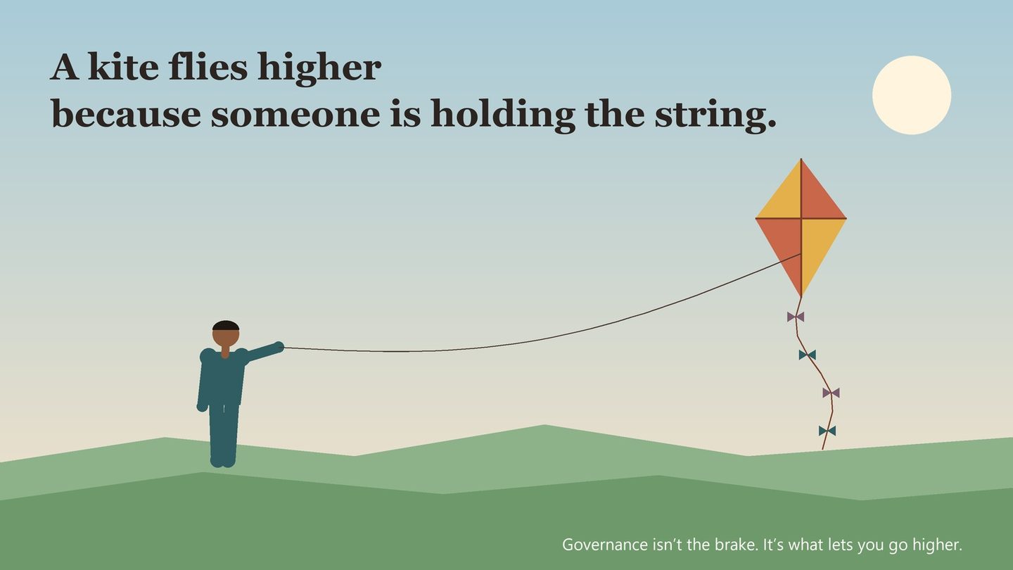 A person on a hillside holding the string of a kite flying high into a bright sky.